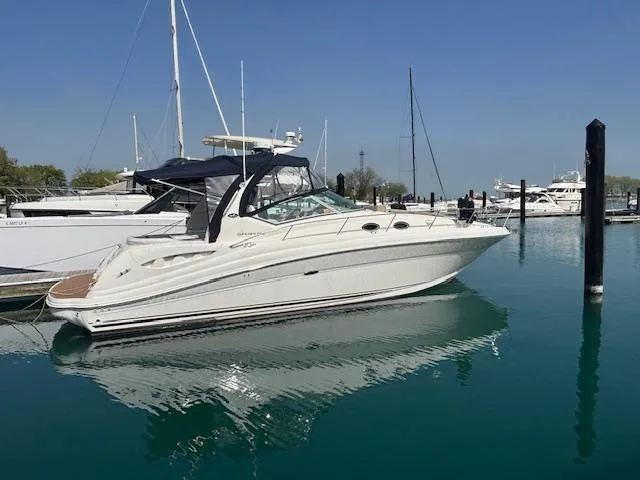 Slide: The Image of 2003 Sea Ray 340 Sundancer yacht docked in a marina on a sunny day. - 9