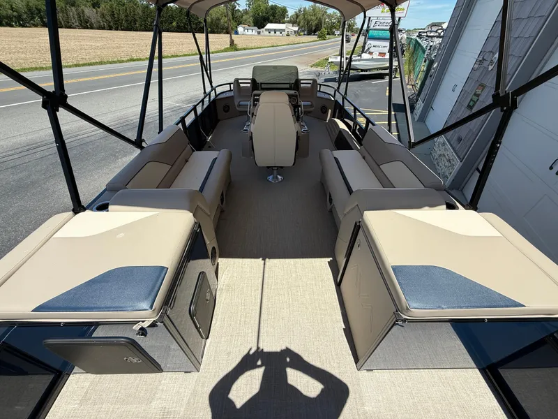 Slide: The Image of 2025 Avalon 2585 Venture 85 Tri Toon boat with center console, beige seating, and high-performance design. - 12