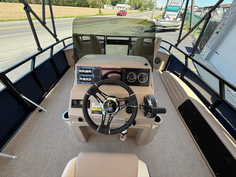 Slide: The Image of 2025 Avalon 2585 Venture 85 Center Console Fish boat interior with steering wheel and controls. - 14