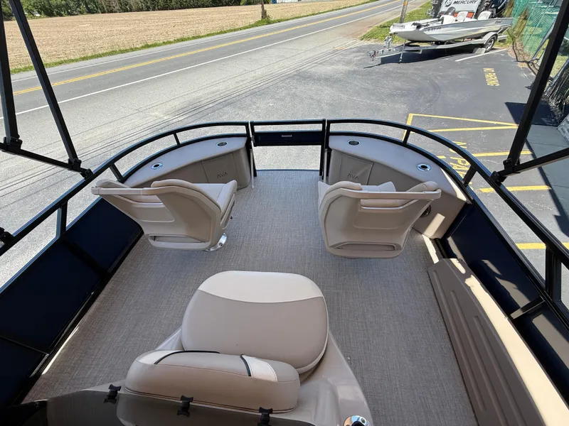 Slide: The Image of 2025 Avalon 2585 Venture 85 Tri Toon boat with center console and seating, parked near road. - 15
