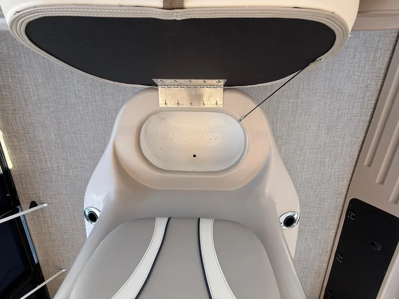 Slide: The Image of 2025 Avalon 2585 Venture 85 center console with open storage compartment, showcasing sleek design. - 21