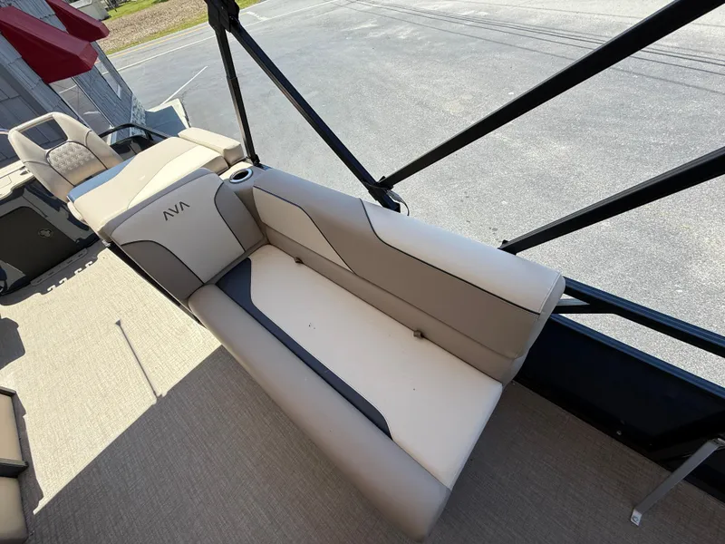 Slide: The Image of 2025 Avalon 2585 Venture boat interior with beige seating and cup holder. - 22