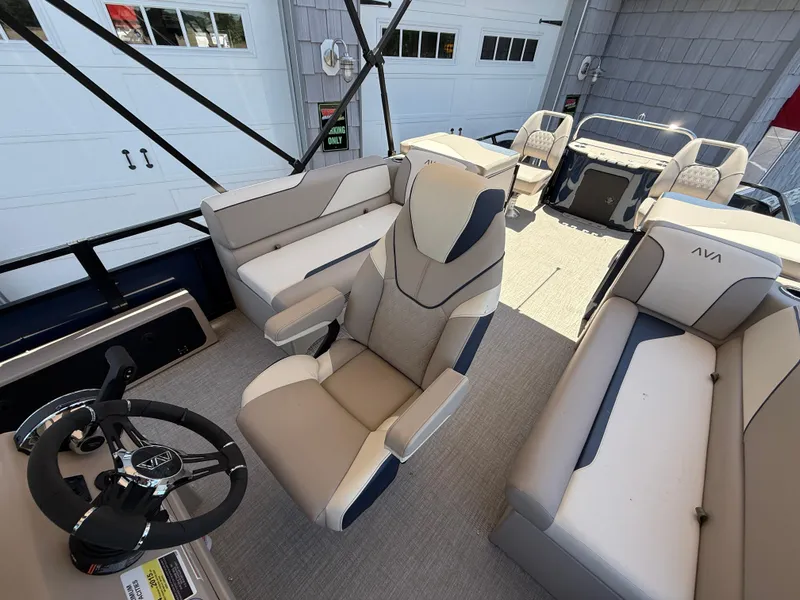 Slide: The Image of 2025 Avalon 2585 Venture 85 boat interior with center console, plush seating, and steering wheel. - 23