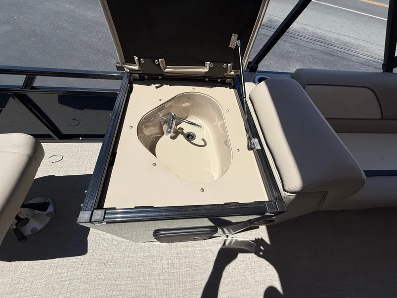 Slide: The Image of 2025 Avalon 2585 Venture boat with open center console storage compartment. - 31