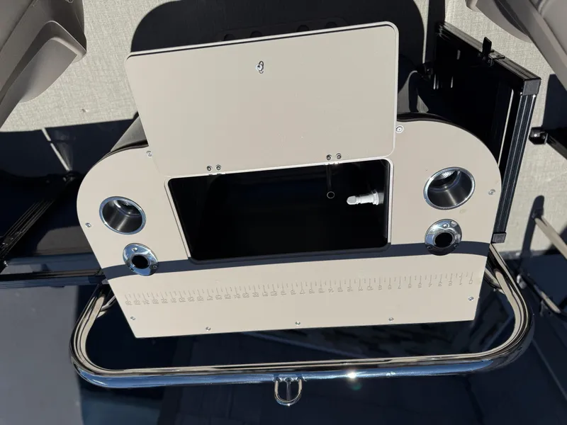Slide: The Image of 2025 Avalon 2585 Venture Center Console Fish boat dashboard with cup holders and storage compartment. - 32