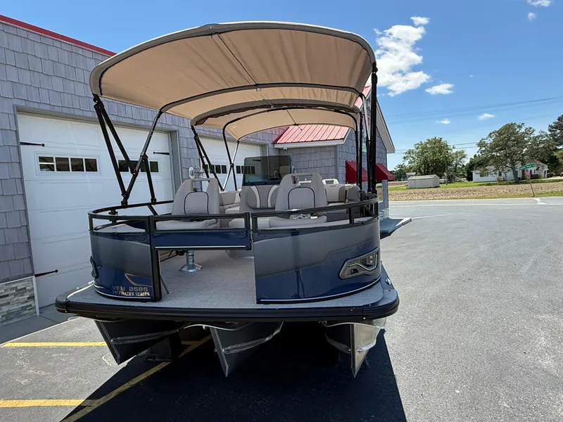 Slide: The Image of 2025 Avalon 2585 Venture pontoon boat with canopy, parked outdoors. - 4