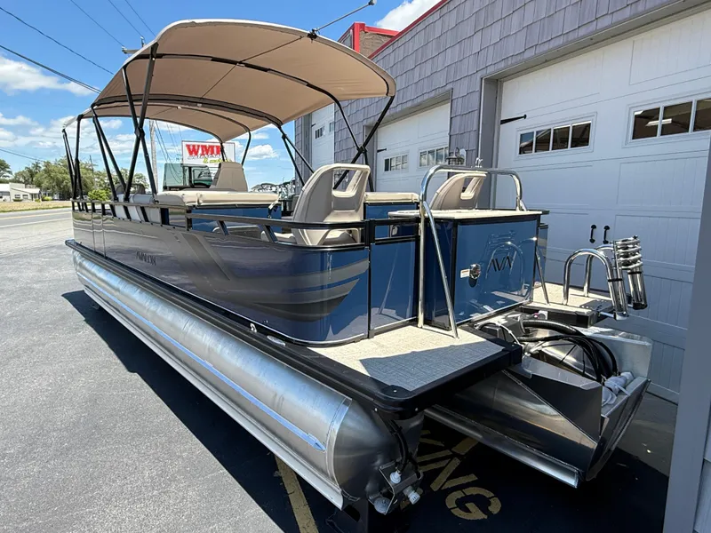Slide: The Image of 2025 Avalon 2585 Venture 85 Tri Toon boat with center console, parked outdoors. - 6