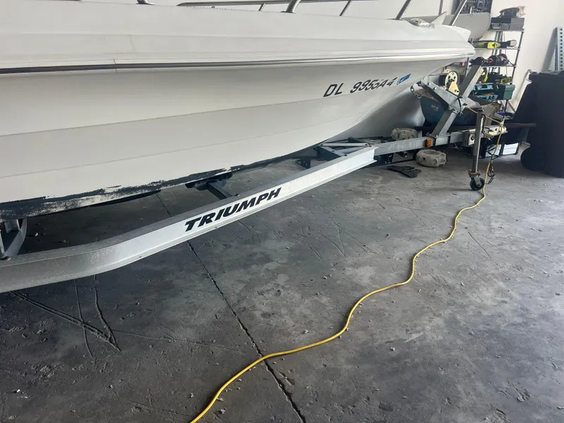 Slide: The Image of 2009 Triumph 190 Bay boat on trailer in garage setting. - 10