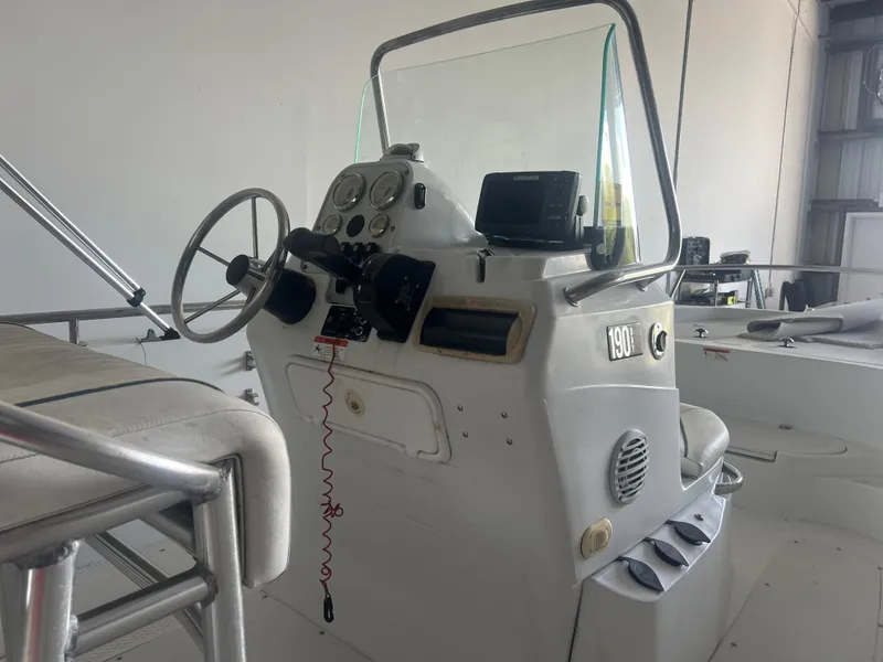 Slide: The Image of 2009 Triumph 190 Bay boat console with steering wheel and controls in a storage area. - 3