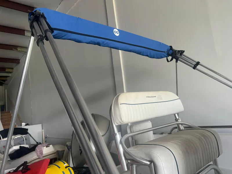 Slide: The Image of 2009 Triumph 190 Bay Stock #C80 boat interior with blue canopy and white seating. - 9