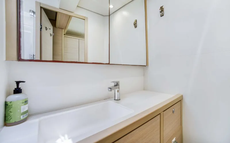 Slide: The Image of Modern bathroom interior on 2020 Lagoon 620 yacht with sleek sink and mirror. - 11