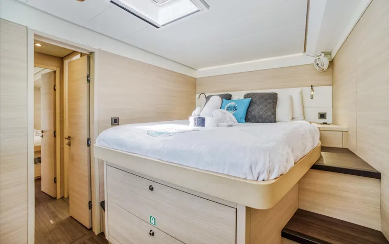 Slide: The Image of Luxurious bedroom interior of 2020 Lagoon 620 yacht with modern design and cozy bedding. - 12