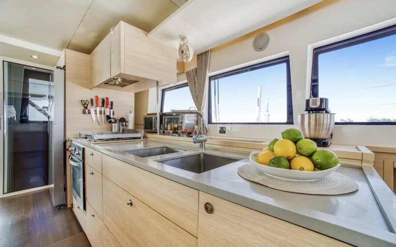 Slide: The Image of Modern kitchen interior on 2020 Lagoon 620 yacht with sleek design and ample natural light. - 4