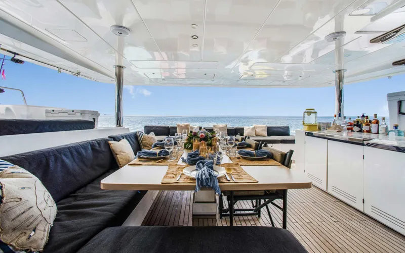 Slide: The Image of Luxurious Lagoon 620 yacht dining area with elegant table setting, ocean view, and modern amenities. - 7