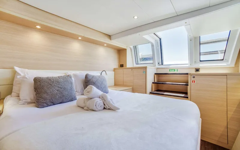 Slide: The Image of Luxurious bedroom interior of 2020 Lagoon 620 yacht with skylight and modern decor. - 8