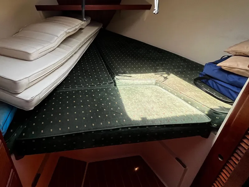 Slide: The Image of Cozy cabin interior of 1987 Catalina 34 sailboat with cushions and storage. - 19