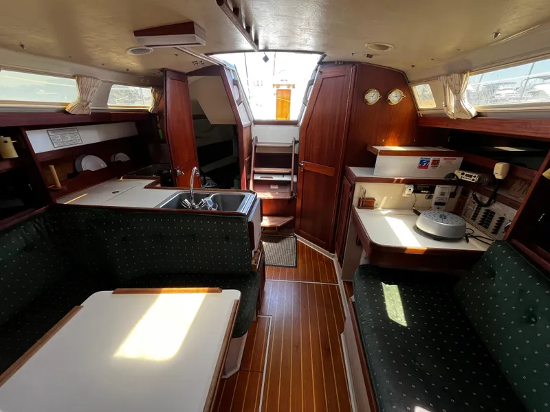 Slide: The Image of Interior of 1987 Catalina 34 sailboat with wood finish and seating area. - 21