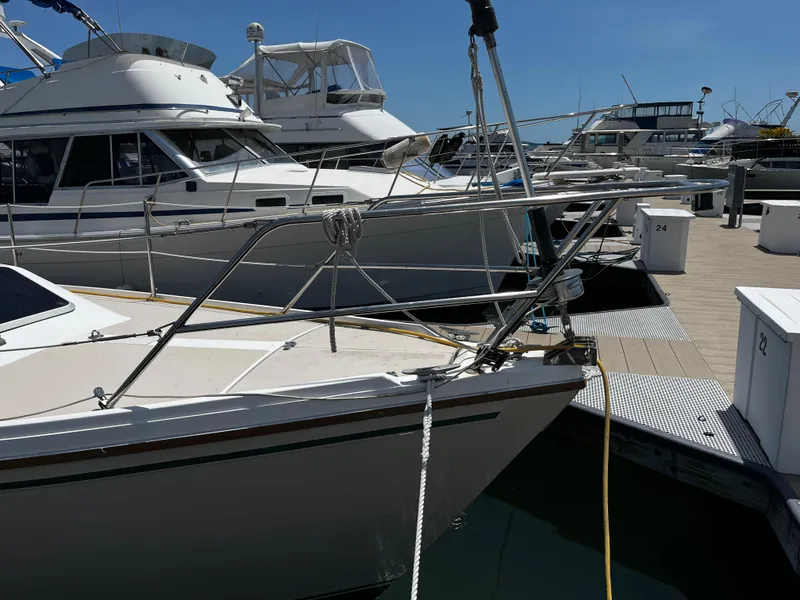 Slide: The Image of 1987 Catalina 34 sailboat docked at marina with other boats. - 4