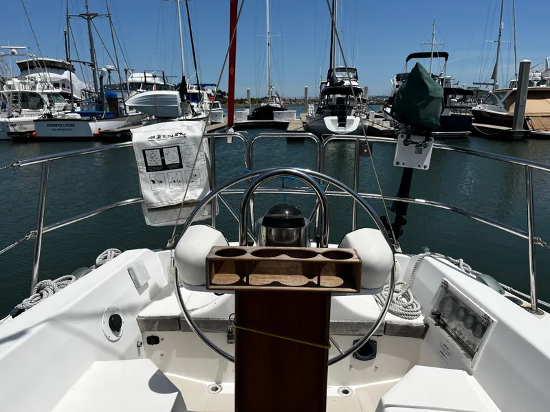 Slide: The Image of Cockpit view of a 1987 Catalina 34 sailboat docked in a marina. - 9