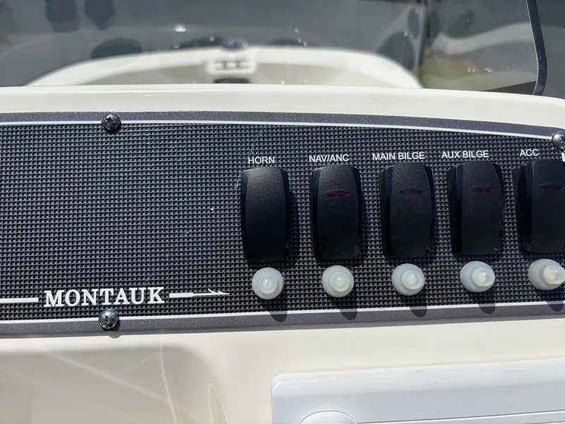 Slide: The Image of Control panel of 2024 Boston Whaler 170 Montauk boat with labeled switches. - 11