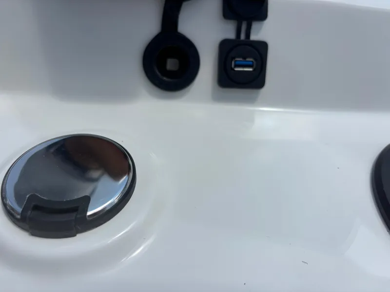 Slide: The Image of 2024 Boston Whaler 170 Montauk dashboard with USB port and chrome detail. - 13