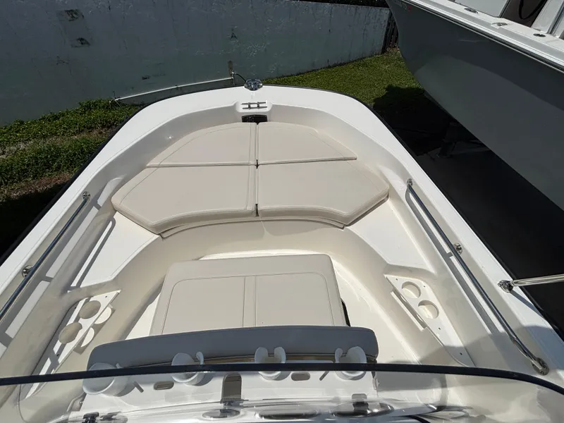 Slide: The Image of 2024 Boston Whaler 170 Montauk boat interior with cushioned seating and cup holders. - 15