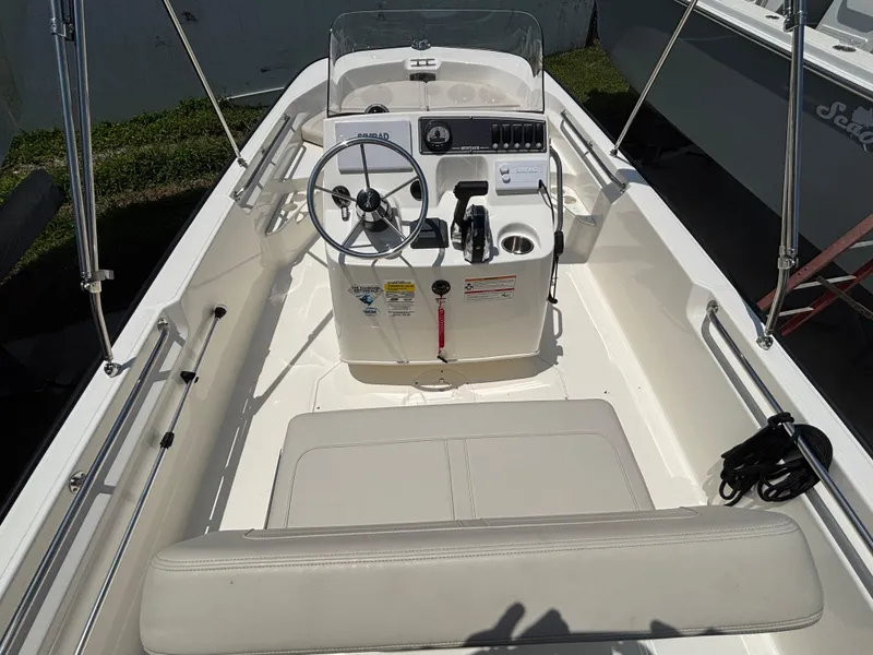 Slide: The Image of 2024 Boston Whaler 170 Montauk boat interior with steering console and seating. - 16