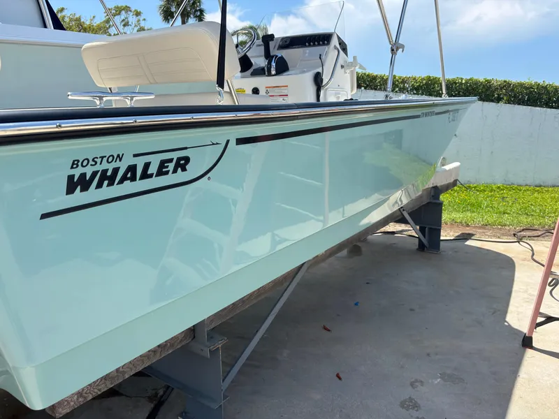 Slide: The Image of 2024 Boston Whaler 170 Montauk boat on stand, side view. - 2