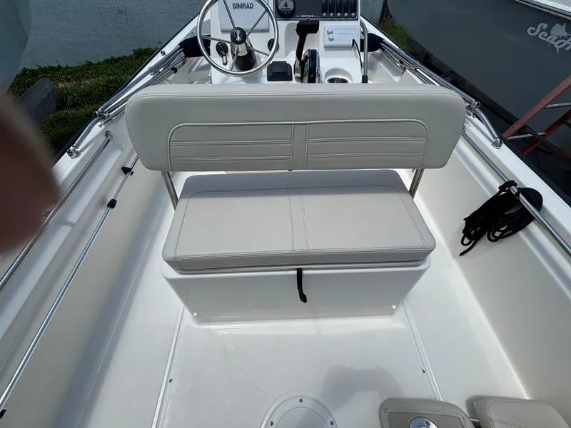 Slide: The Image of 2024 Boston Whaler 170 Montauk boat interior with steering wheel and seating. - 20