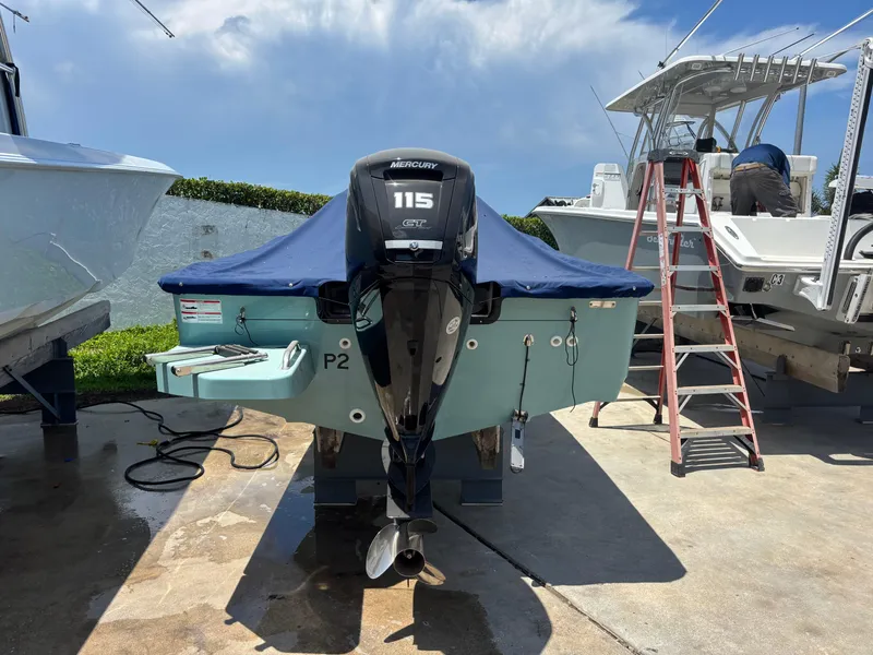 Slide: The Image of 2024 Boston Whaler 170 Montauk with Mercury 115 engine, docked outdoors. - 6