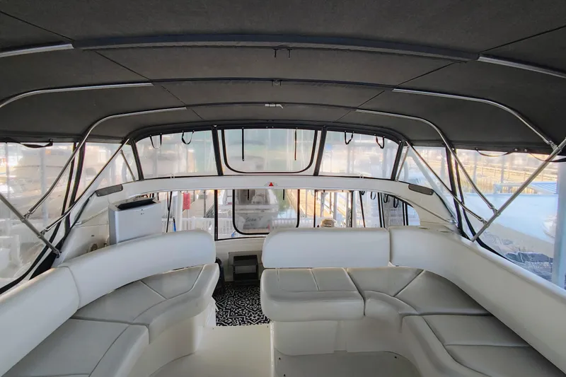 Slide: The Image of Interior view of 2002 Silverton 43 Motor Yacht with spacious seating and panoramic windows. - 12