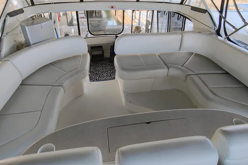 Slide: The Image of 2002 Silverton 43 Motor Yacht interior with spacious white seating and elegant design. - 13