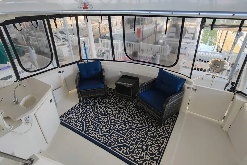 Slide: The Image of Luxurious 2002 Silverton 43 Motor Yacht interior with seating and elegant decor. - 14