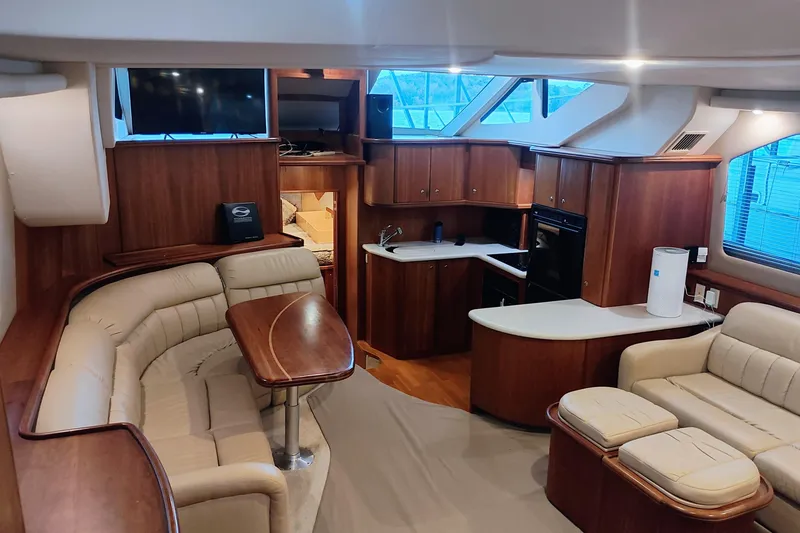 Slide: The Image of Interior of 2002 Silverton 43 Motor Yacht with elegant wood finish and plush seating. - 16