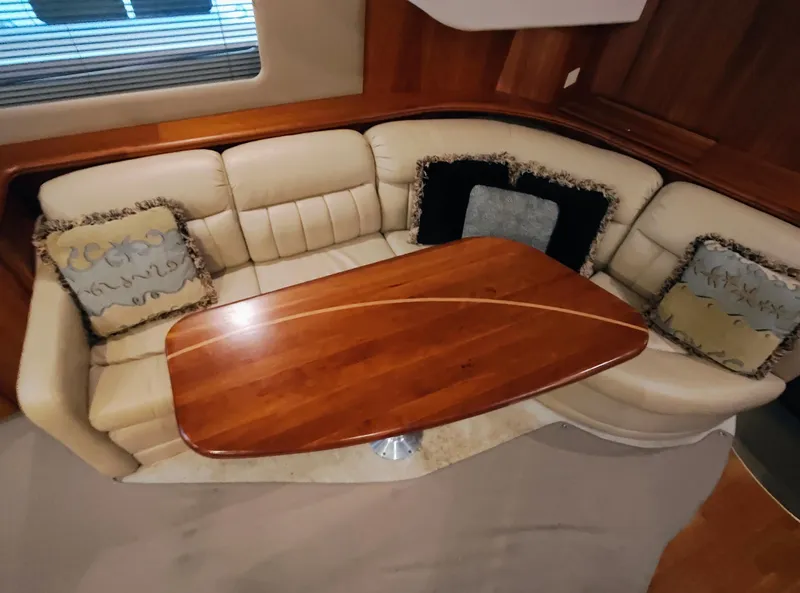 Slide: The Image of Luxurious interior of 2002 Silverton 43 Motor Yacht with elegant wood table and plush seating. - 18
