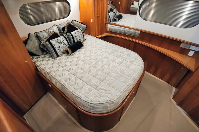 Slide: The Image of Luxurious bedroom interior of 2002 Silverton 43 Motor Yacht with elegant bedding and wood accents. - 19