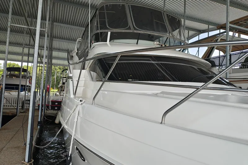 Slide: The Image of 2002 Silverton 43 Motor Yacht docked in a covered marina. - 2