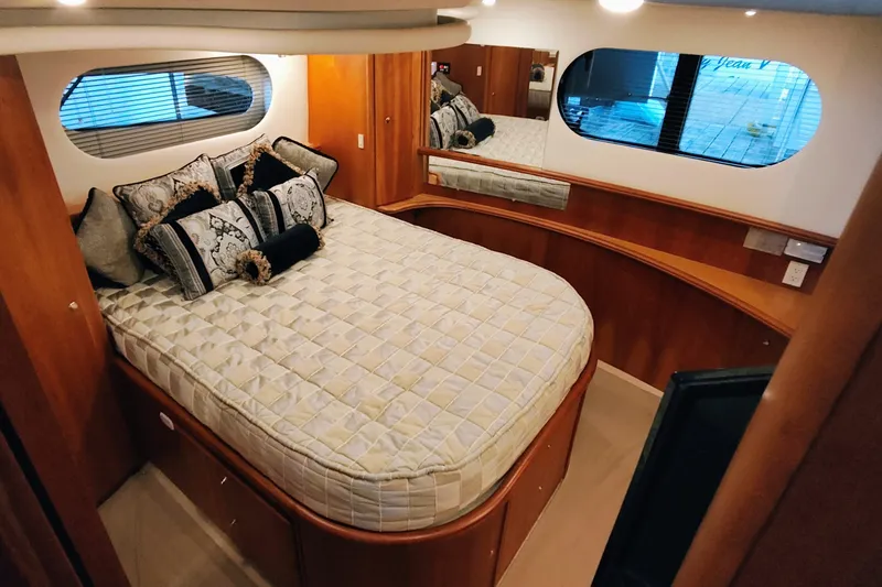Slide: The Image of Luxurious bedroom interior of 2002 Silverton 43 Motor Yacht with elegant bedding and wood accents. - 23