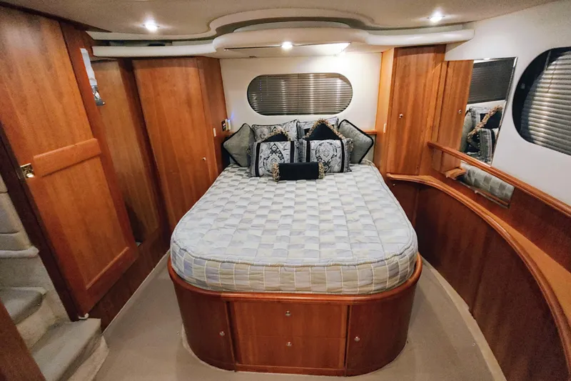 Slide: The Image of Luxurious cabin interior of a 2002 Silverton 43 Motor Yacht with elegant wood finishes. - 24