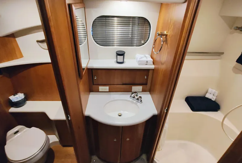 Slide: The Image of Luxurious bathroom in 2002 Silverton 43 Motor Yacht with wood accents and modern amenities. - 27