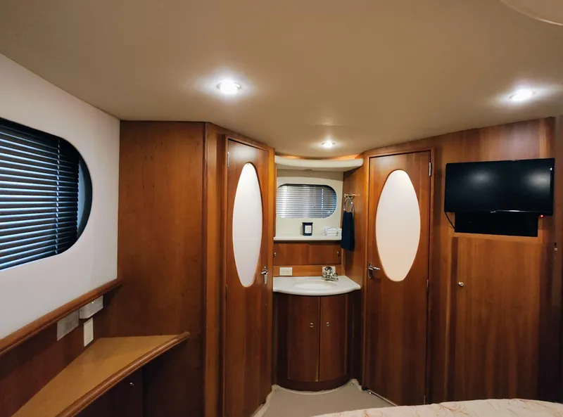 Slide: The Image of Luxurious interior of 2002 Silverton 43 Motor Yacht with wood paneling and modern amenities. - 30