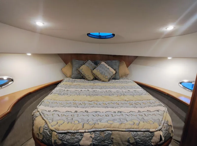 Slide: The Image of Luxurious bedroom interior of 2002 Silverton 43 Motor Yacht with elegant bedding and ambient lighting. - 31