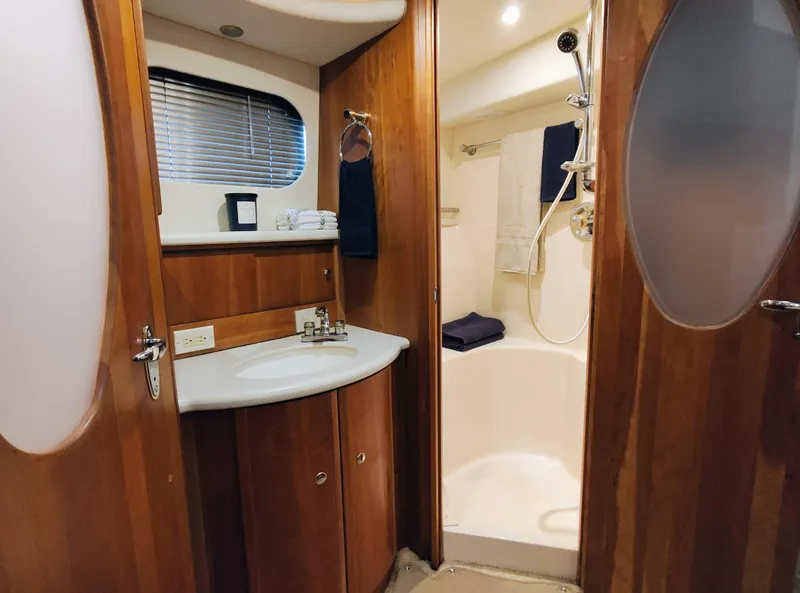 Slide: The Image of Luxurious bathroom in 2002 Silverton 43 Motor Yacht with wood accents and modern fixtures. - 33