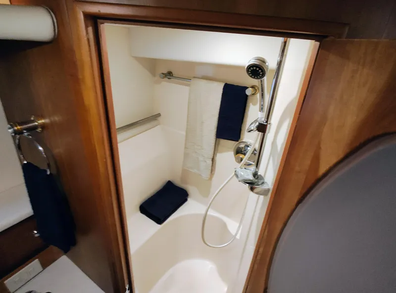 Slide: The Image of Shower area in 2002 Silverton 43 Motor Yacht with towels and handheld showerhead. - 37