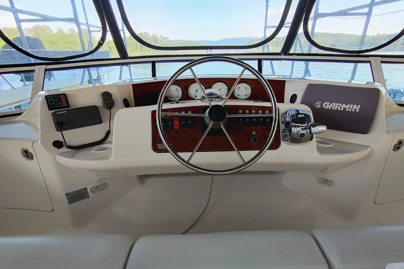 Slide: The Image of Helm of 2002 Silverton 43 Motor Yacht with Garmin navigation system and classic steering wheel. - 6