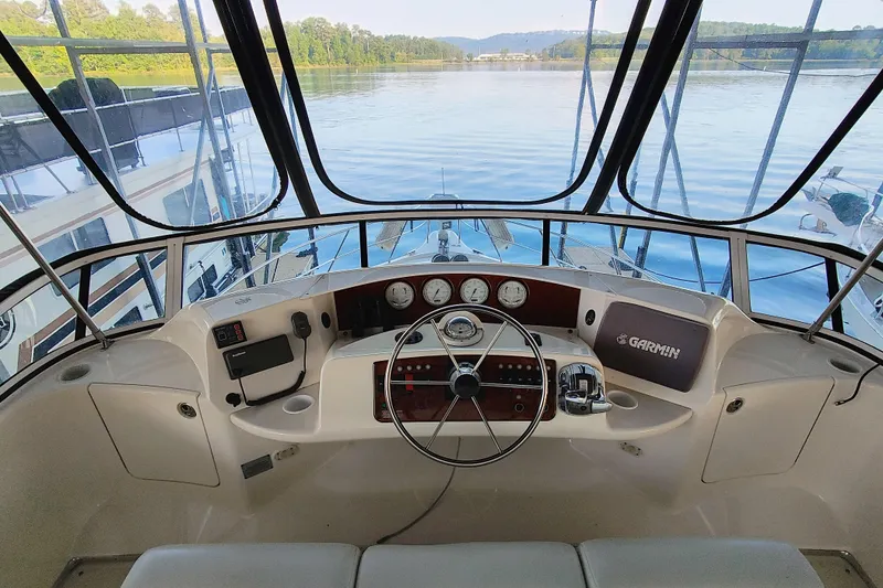 Slide: The Image of 2002 Silverton 43 Motor Yacht helm with steering wheel and navigation instruments. - 7
