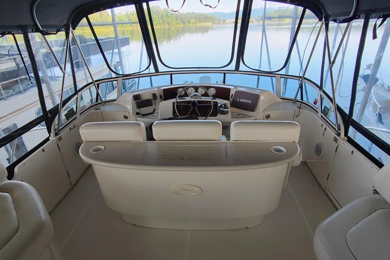 Slide: The Image of Interior view of 2002 Silverton 43 Motor Yacht helm with panoramic water view. - 8