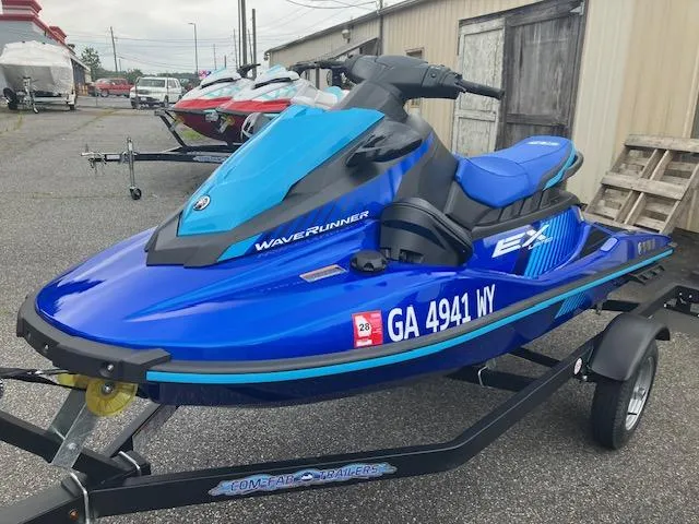 Slide: The Image of 2023 Yamaha WaveRunner EX Limited in blue on a trailer, parked outdoors. - 3