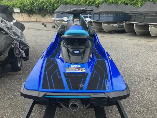 Slide: The Image of 2023 Yamaha WaveRunner EX Limited in vibrant blue, parked outdoors. - 4
