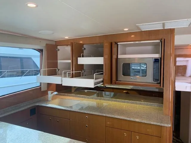 Slide: The Image of Luxurious kitchen interior of 2002 Viking 55 Convertible yacht with modern appliances and ample storage. - 18
